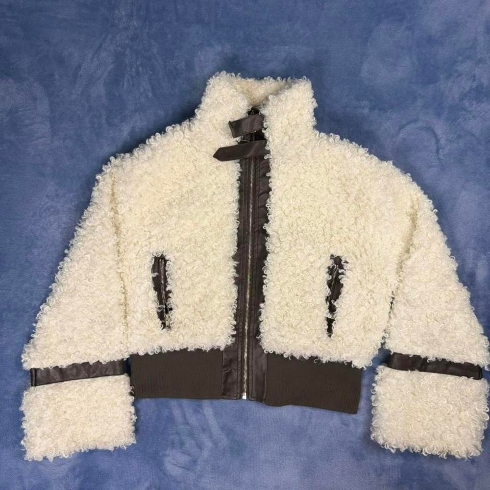 White faux fur jacket with black  leather‎ trim and zipper details. Size: L